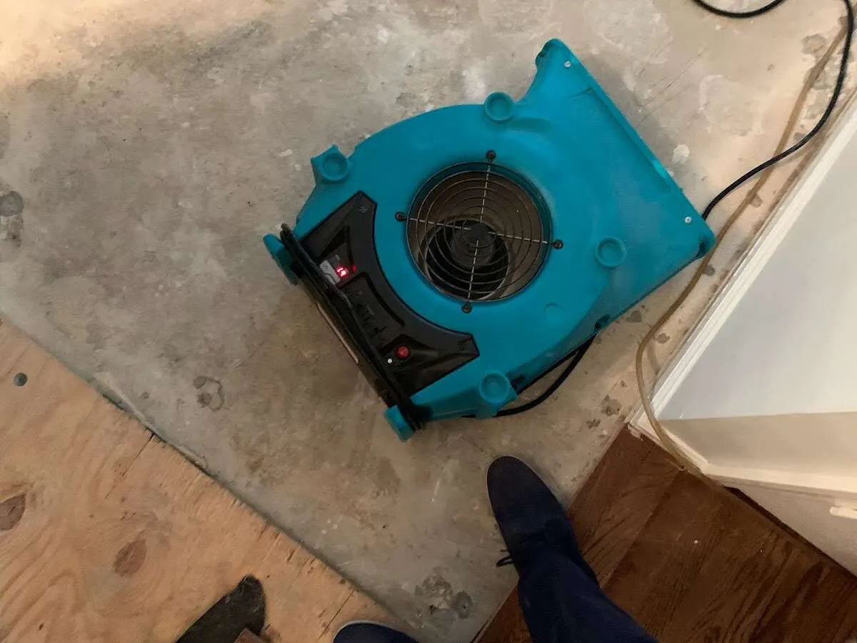 Air mover drying subfloor during Commercial Water Damage Restoration in York